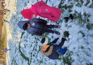 Dzieci lepią kule śnegową