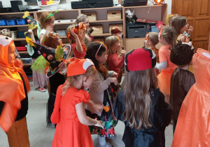 Dzieci tańczą w strojach jesiennych stworów.